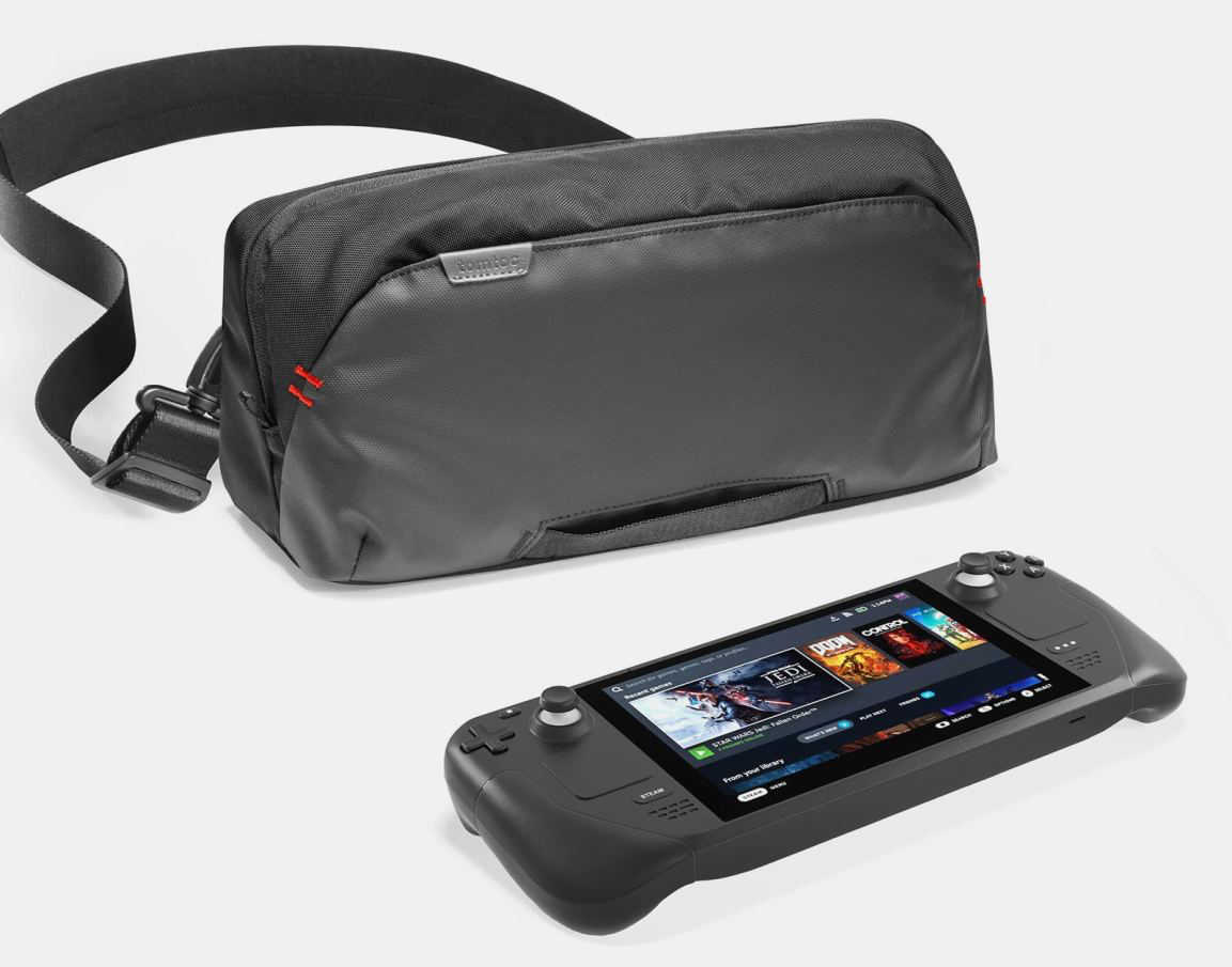 Open tomtoc hard shell carrying case holding a handheld gaming console with accessory pockets
